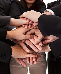 Businesspeople collaborating and coming together as a team