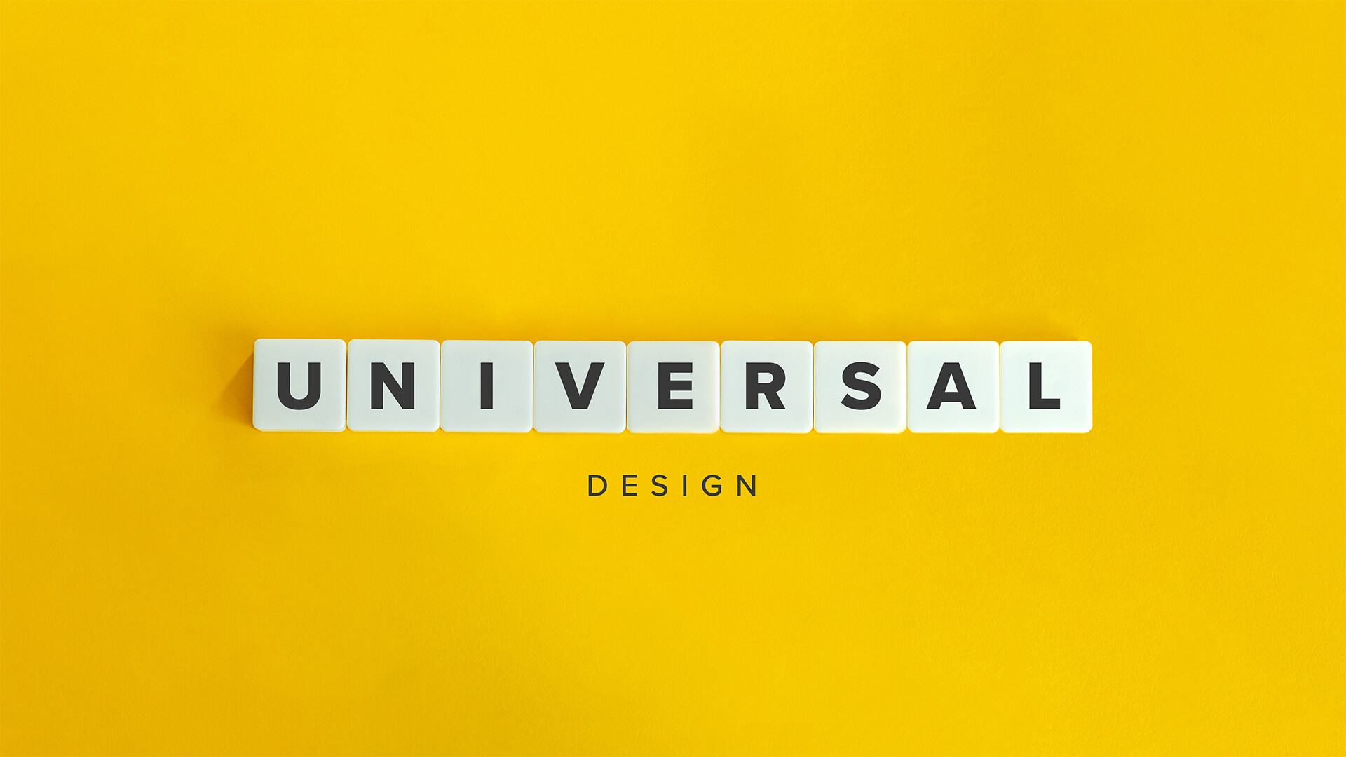 Yellow Card with UNIVERSAL spelled out in Scrabble letters