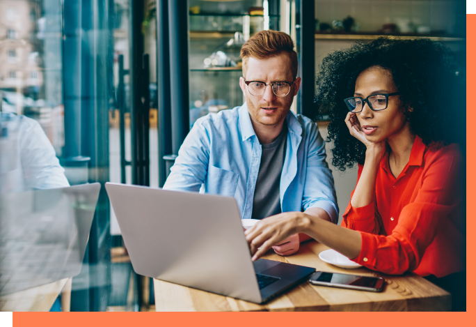 Two people at computer, one pointing at screen, addressing Zoom fatigue in remote workforces