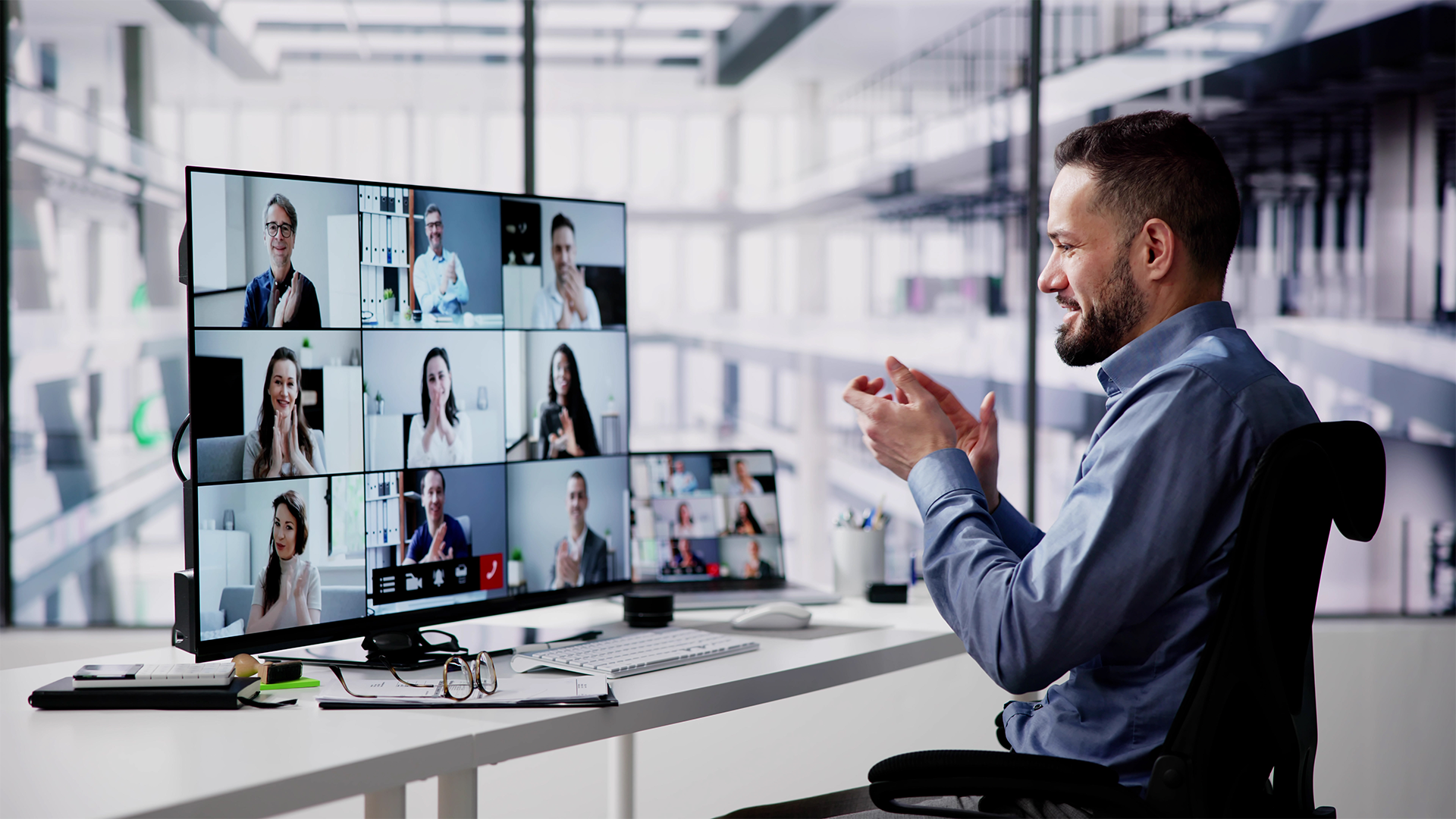 A man enjoys an interactive training on a large monitor.