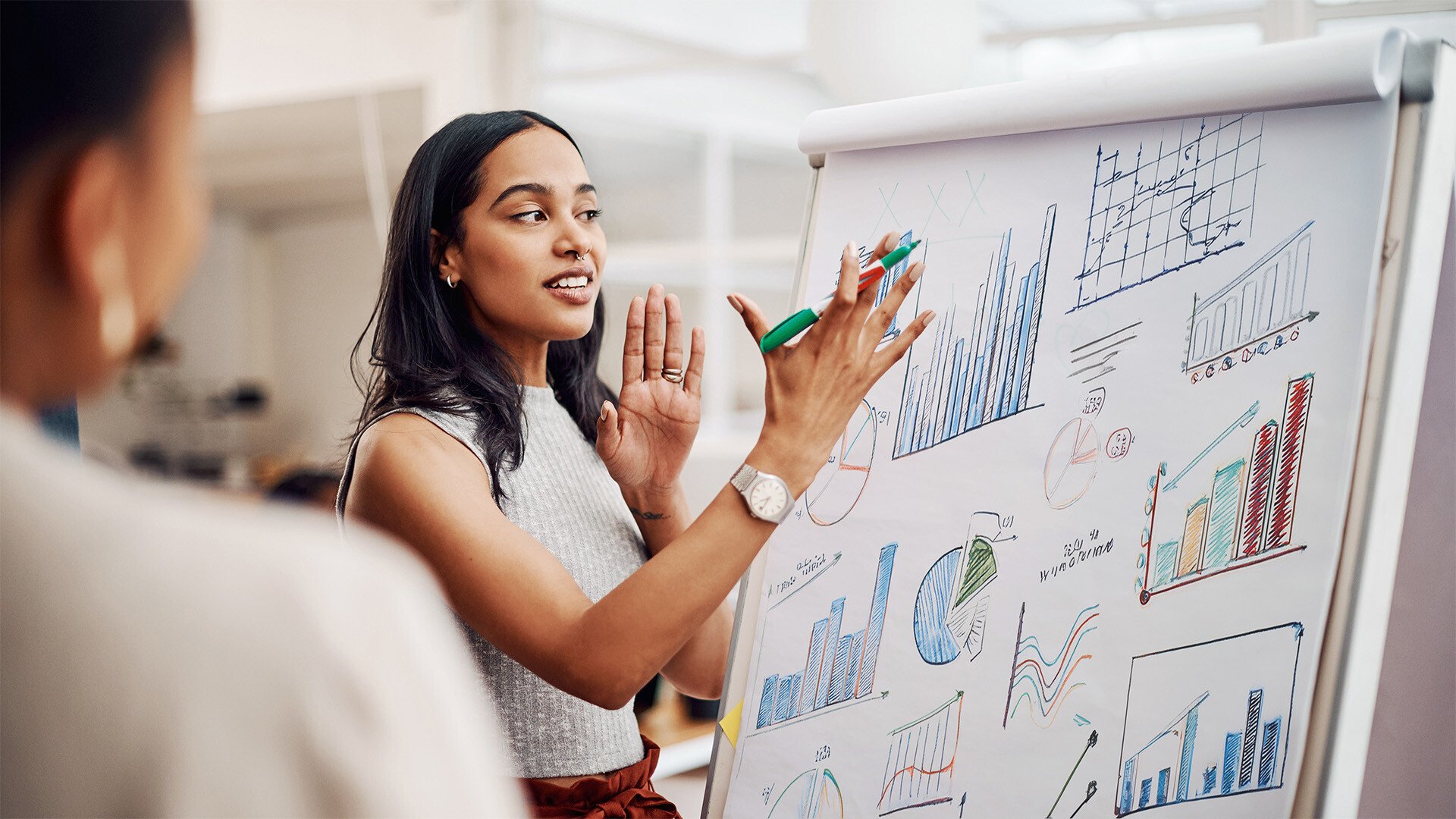 A woman explains the data on graphs 