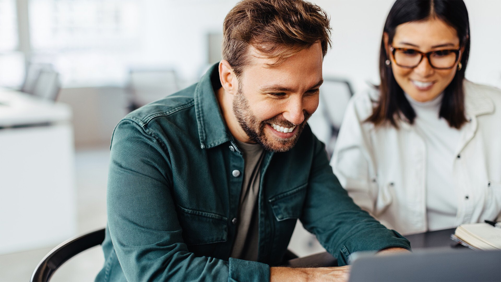 Two People Looking at Laptop and enjoying the experience
