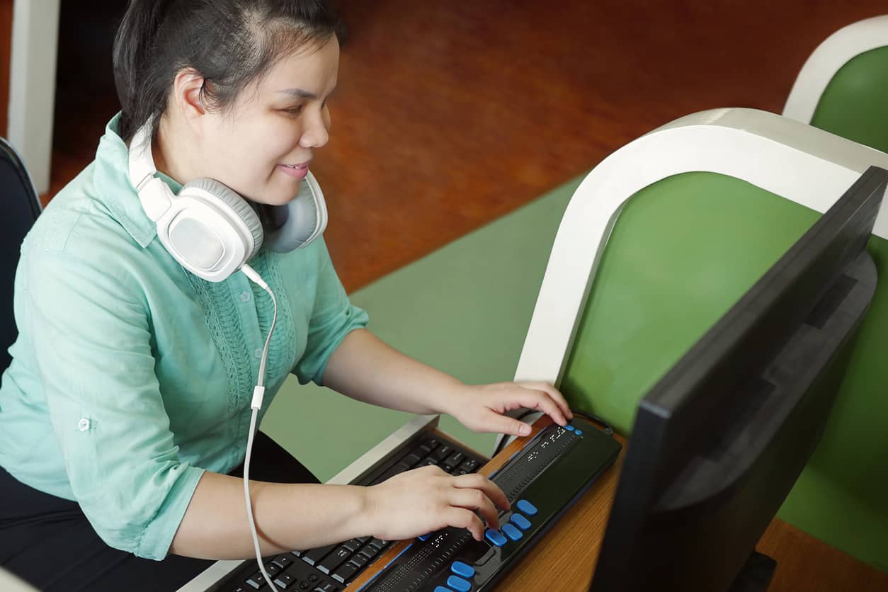 accessible virtual training where a blind lady is using braille for her learning
