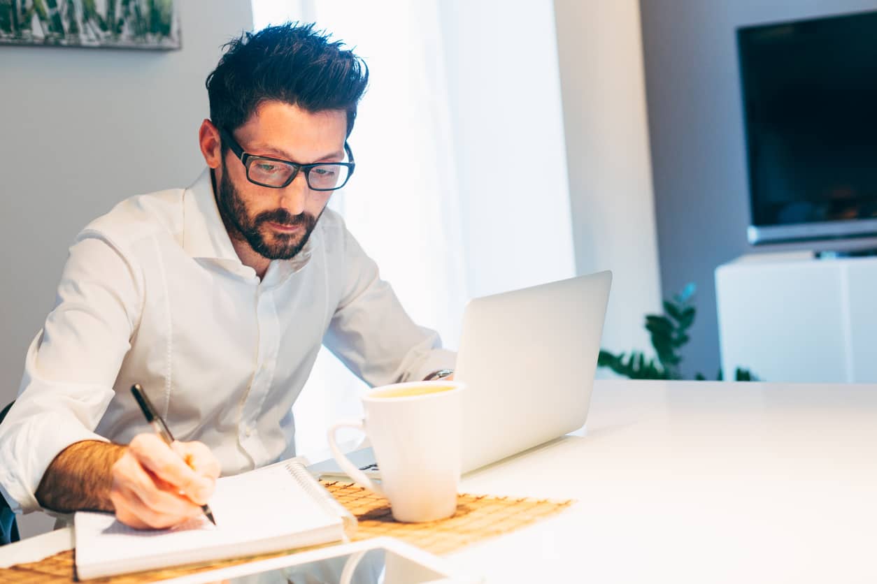 Male Learner in Virtual Class Taking Notes 